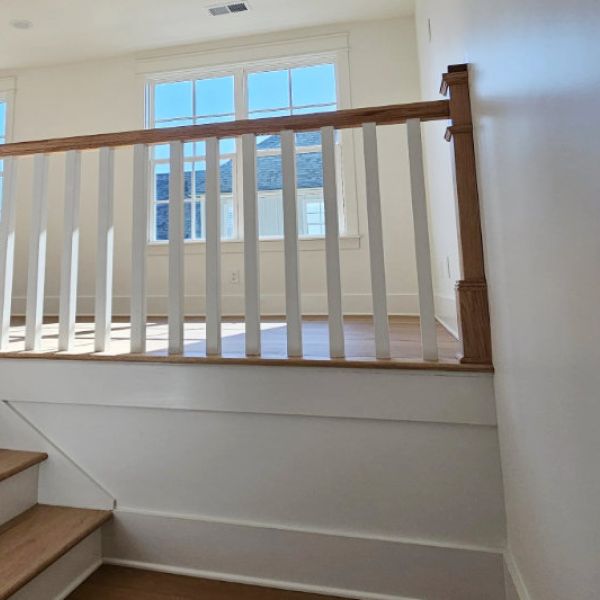 Staircase landing with wood spindles.